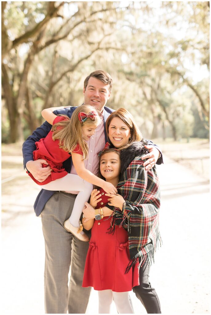 Family of 4 with 2 daughters take a family picture for their Christmas picture during fall family mini session in Wormsloe with Savannah family photographer, Wisp + Willow Photography Co.