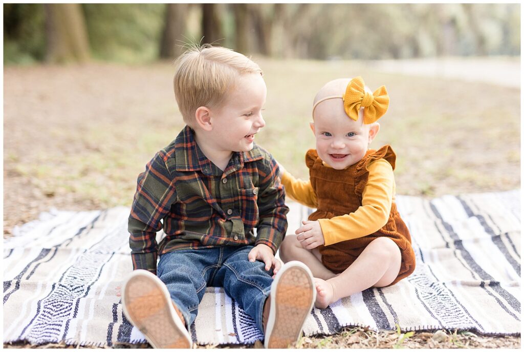 Savannah family photographer, Wisp + Willow Photography Co. capture brother with little sister during their fall mini session in Wormsloe.
