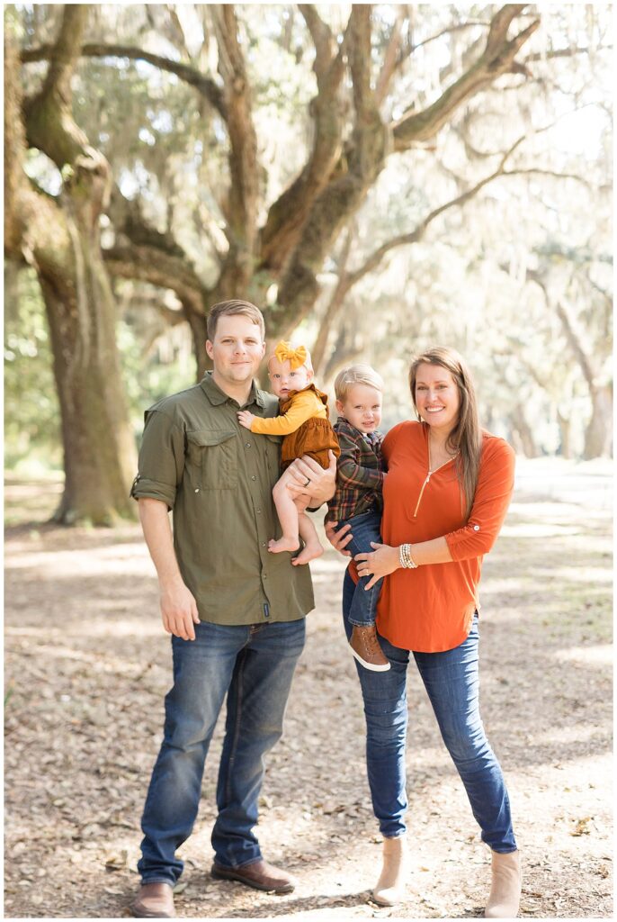Fall family portrait with Savannah family photographer, Wisp + Willow Photography Co., wear coordinate fall color outfits consisting of orange, yellow, brown, and olive green.