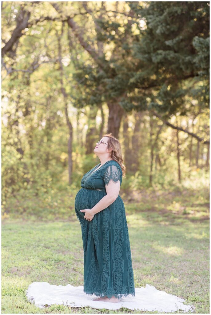 Beautiful maternity mom captured by Wisp + Willow Photography Co. of pregnant mom who looks up to the sky in the takes in the moment of her last pregnancy with her son.