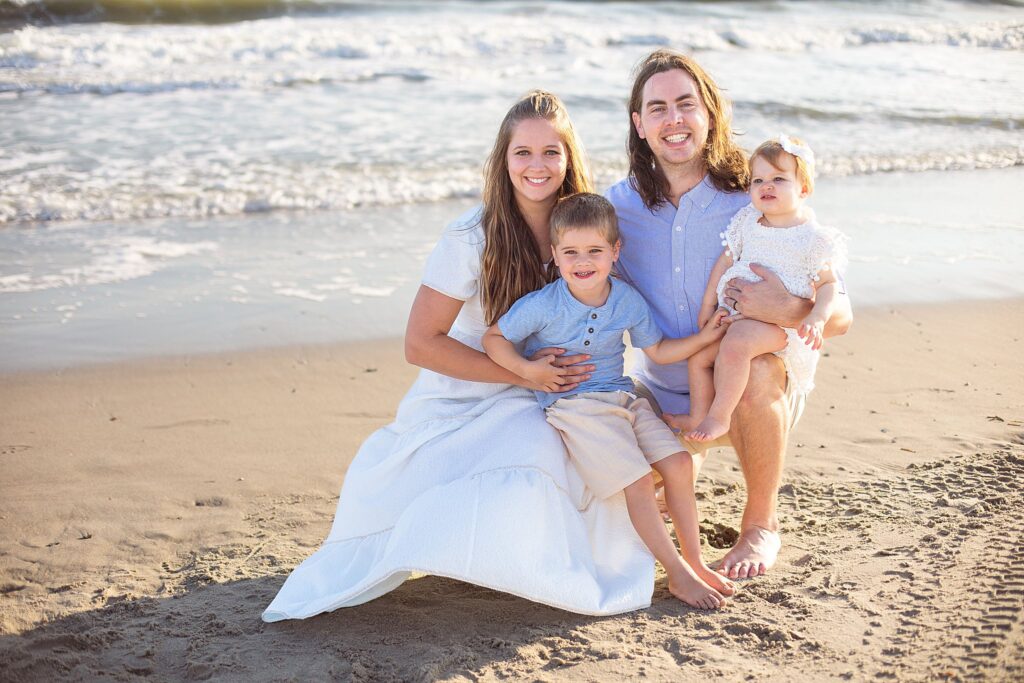 Raleigh family photographer with family of 4 on beach captured by Wisp + Willow Photography Co.