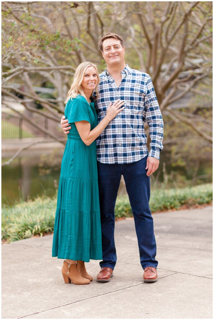 During their family session, a picture of just mom and dad are taken in Raleigh, NC as they coordinate in teal and blue outfits.