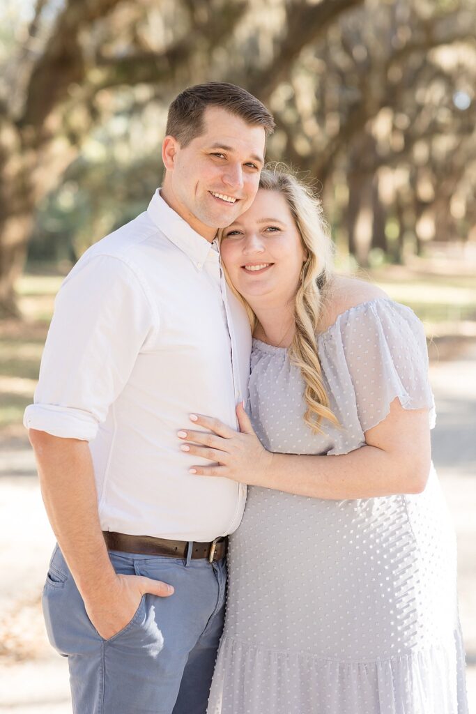 Soon-to-be parents snuggle close together and smile at the camera during their Savannah maternity session before they welcome baby boy.  Check out the blog to see more!