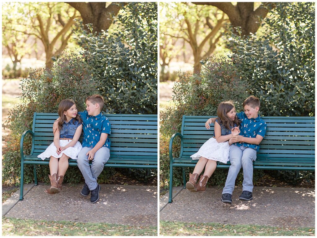Brother and sister sit on green park bench as they look at each and laugh during their Frisco family session.  