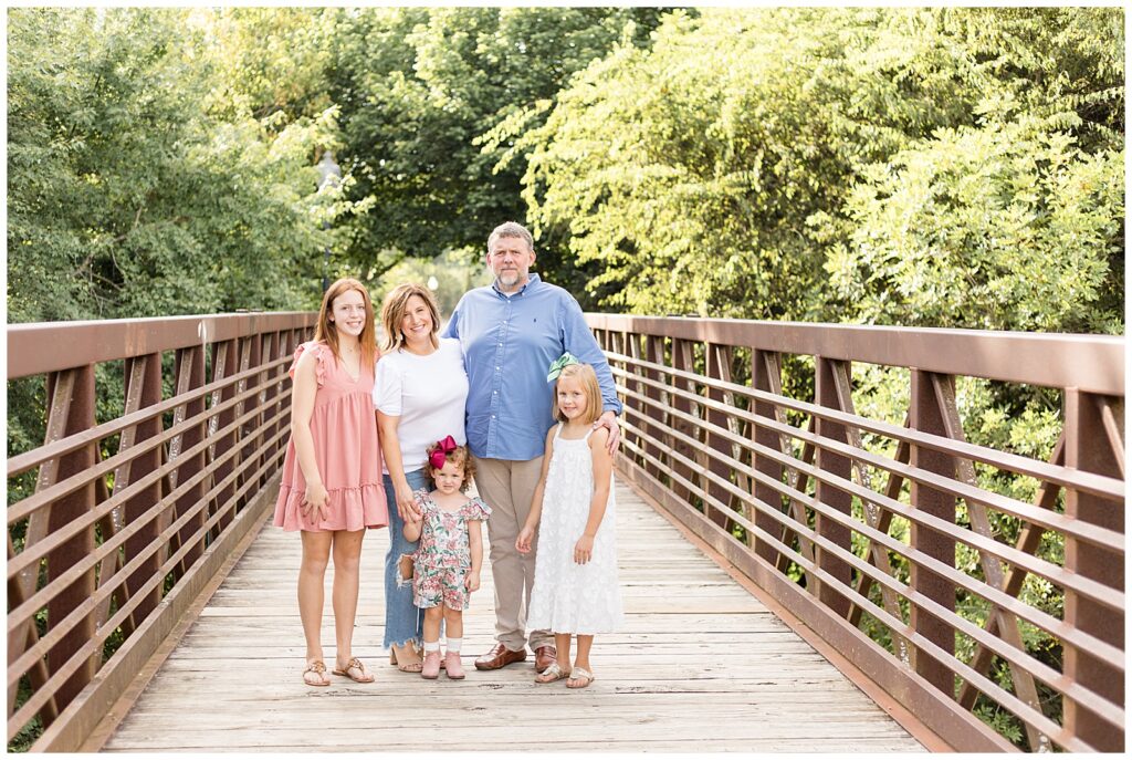 Franklin family portraits at Pinkerton Park in TN with a family of 5 taken by Wisp + Willow Photography Co.  Family coordinates with white, blue, and pink colors.