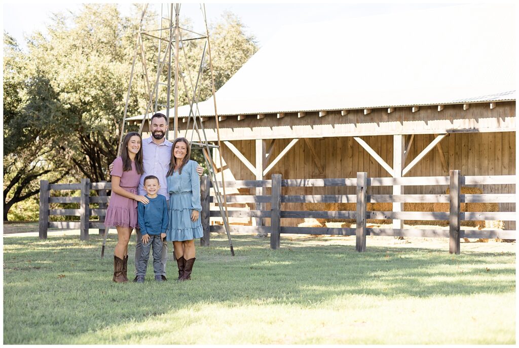 Family of 4 wear country outfits and coordinate in blue, denium, and pink tones and cowboy boots for their family session at Perry Homestead Museum.