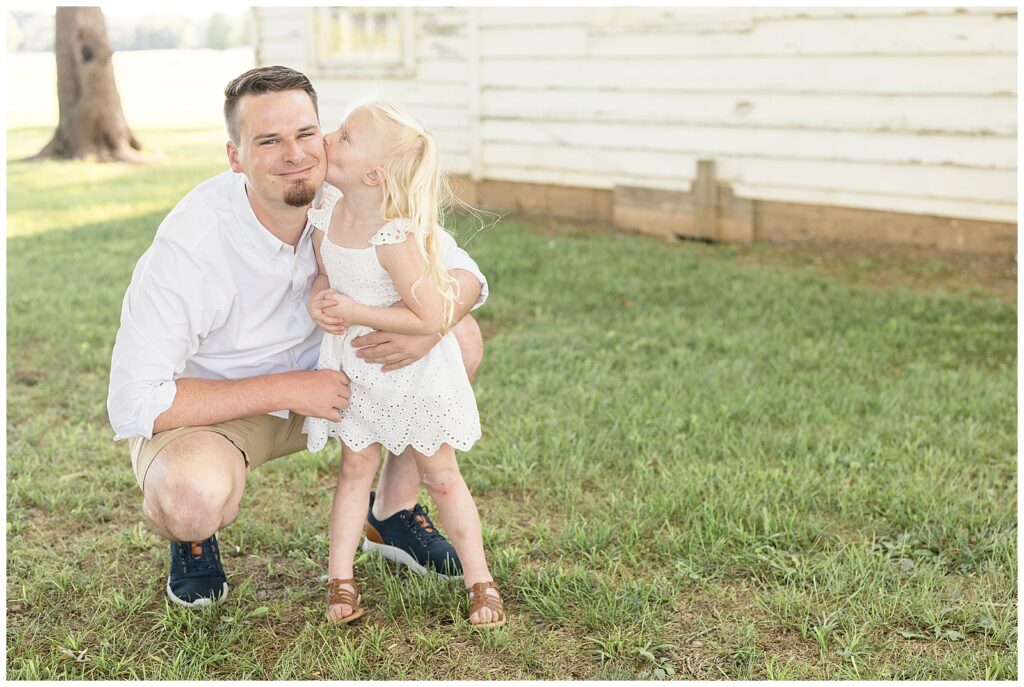 Father daughter moment is captured by Wisp + Willow Photography Co. during a family session at Harlinsdale Farm.