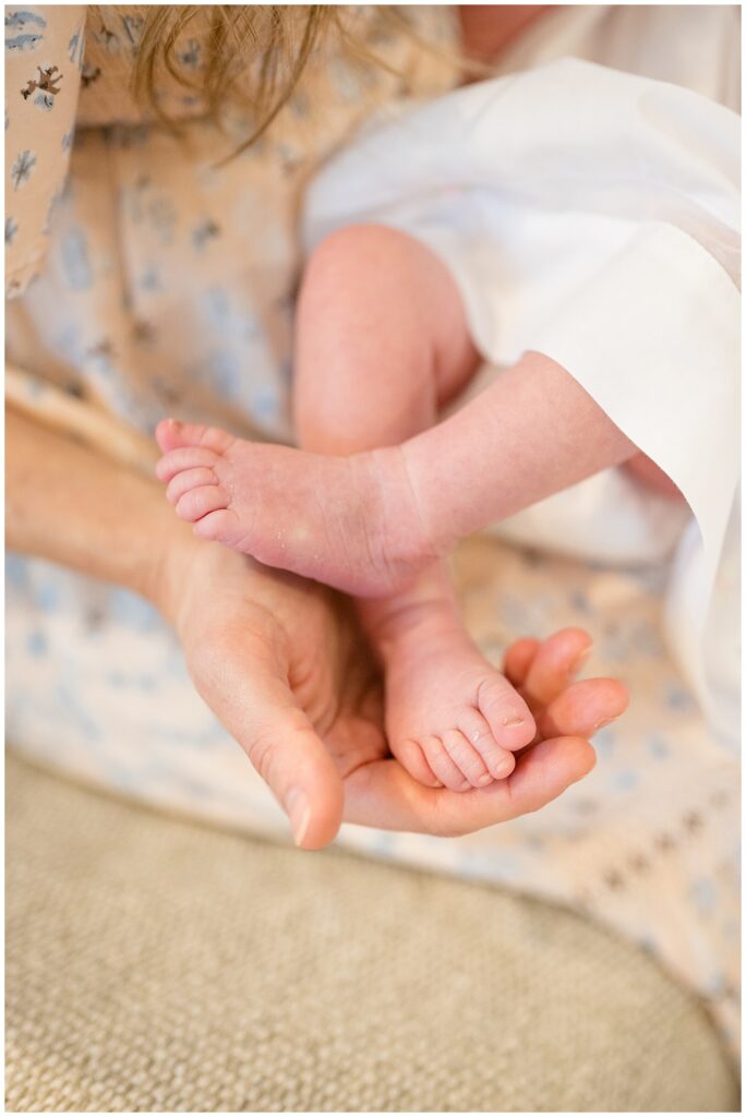 RIchmond newborn photographer, Wisp + Willow Photography Co, capture image of newborn baby detailed picture of her feet crossed and mom holding them in her hand.
