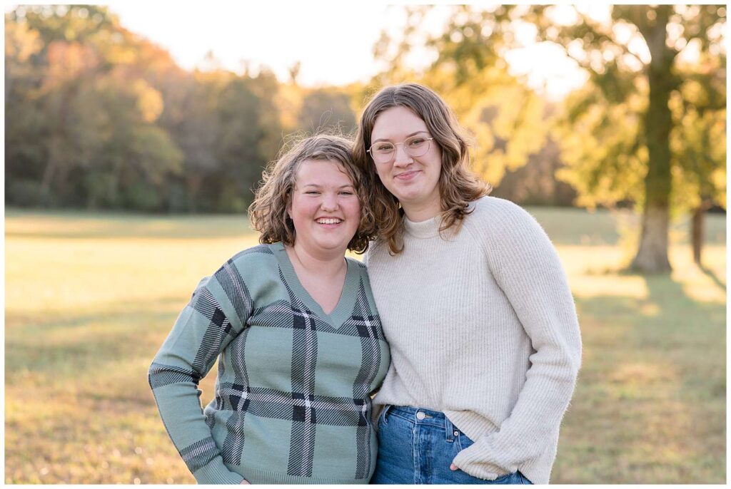 Chattanooga, TN photographer, Wisp + Willow Photography Co., take a picture of two grown sisters in a field for fall portraits.