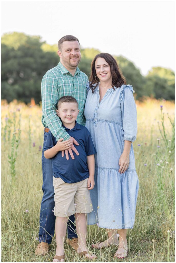A family of 3 stand together in the fields at Erwin Park with Texas photographer, Wisp + Willow Photography Co. for their family portrait session in McKinney, TX!  Click to see more of this family on the blog now!