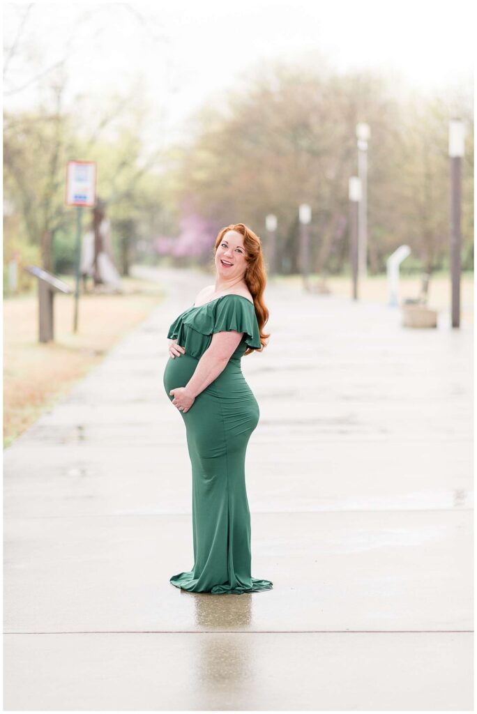 Franklin, TN family photographer takes maternity portraits for mom-to-be who wears a fitted, long, ruffled green dress for her maternity session.