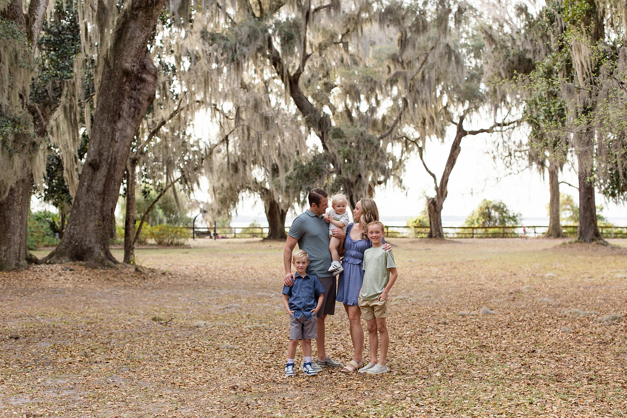 Mom and dad look at one year old son during family session at Alpine Groves Park in Jacksonville, FL with Jacksonville family photographer Wisp + Willow Photography Co. 