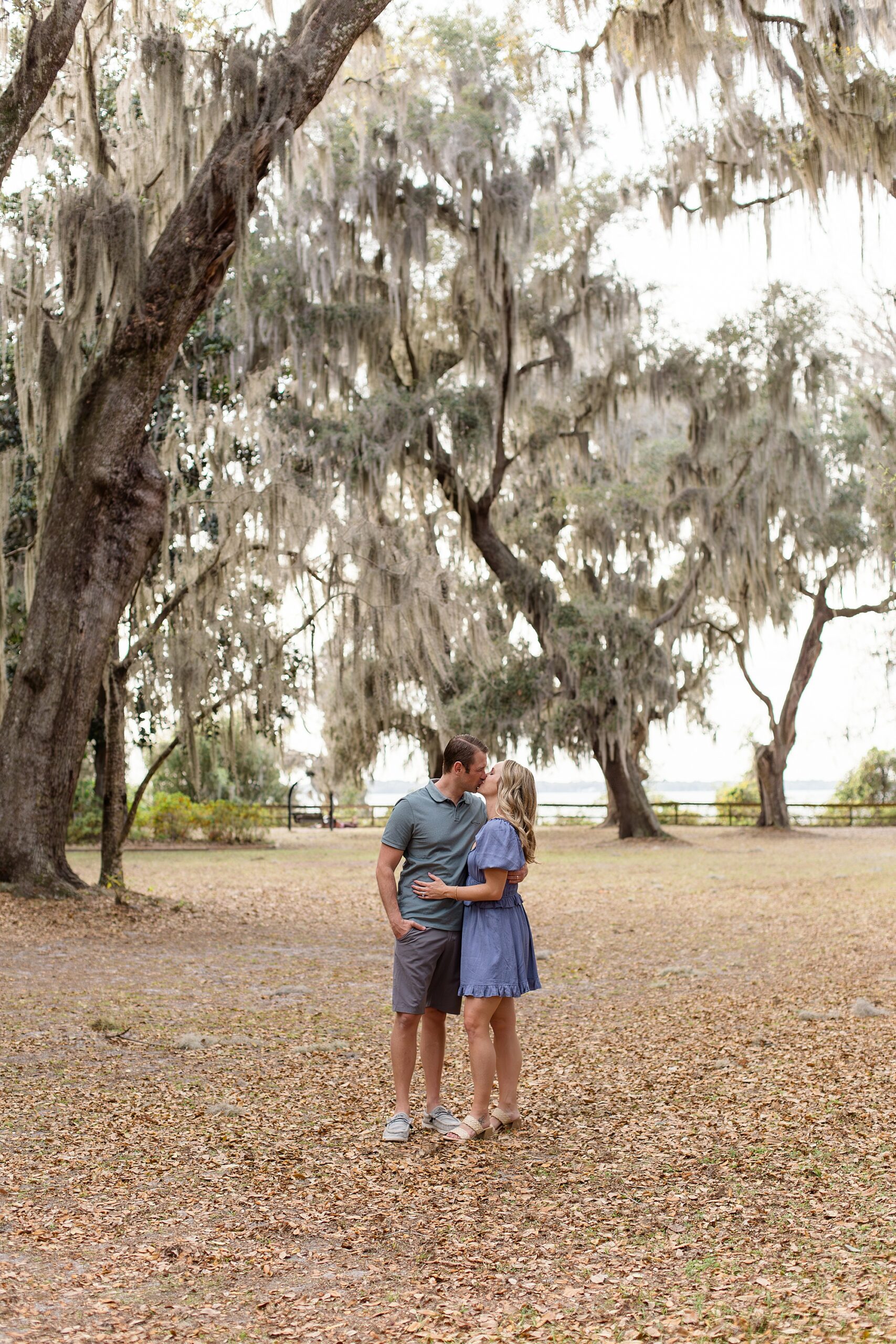 Mom and dad kiss under spanish moss tree at Alpine Groves Park during Jacksonville Family Session with Jax photographer Wisp + Willow Photography Co. 
