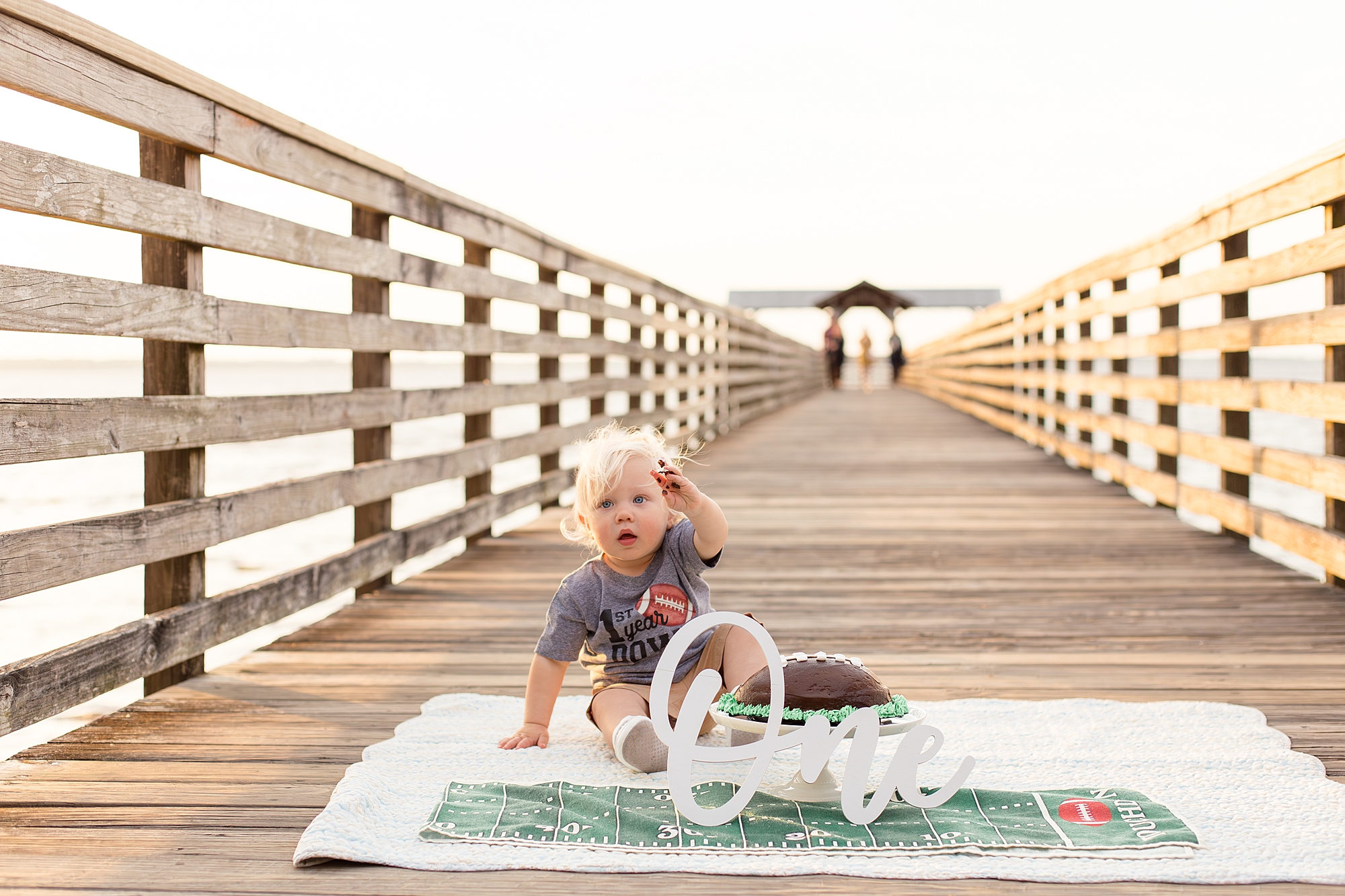 One year old celebrates birthday with smash cake on pier at Alpine Groves Park in Jacksonville, FL with Wisp + Willow Photography Co. 